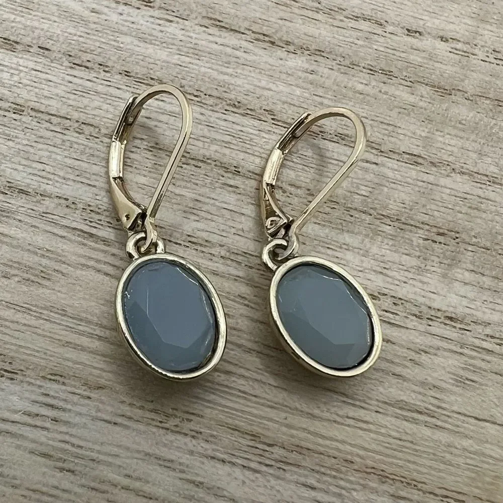 Faceted blue grey hinge dangle earrings on gold tone backing
